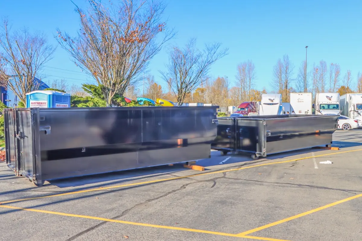 Professional dumpster rental service with roll-off container on residential driveway in Ardmore